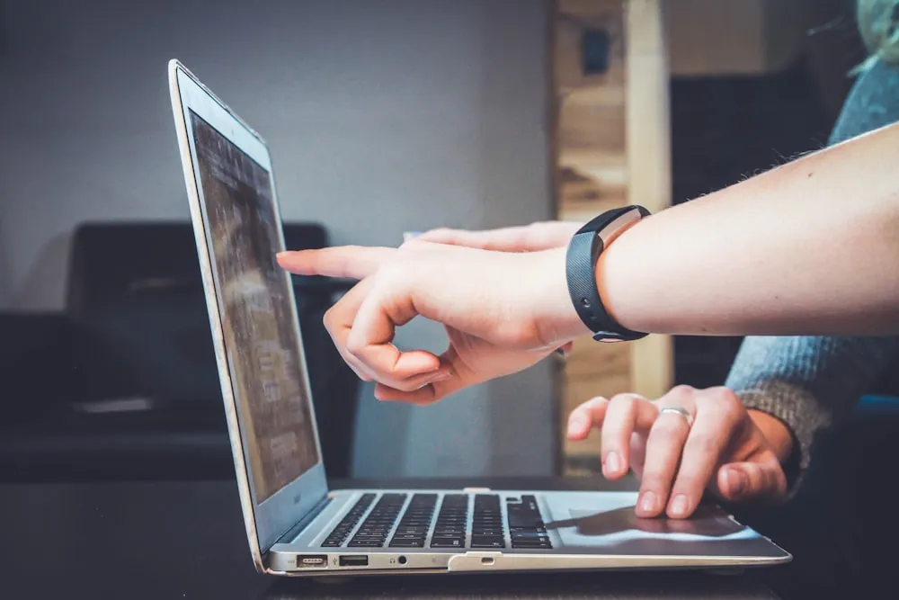 Two people reviewing a laptop screen together