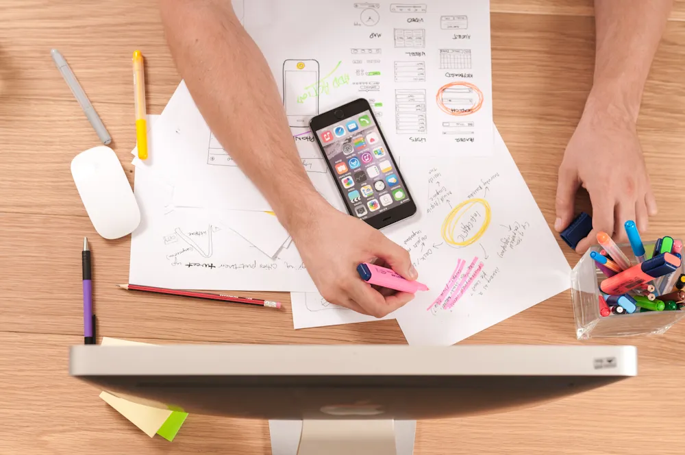 Wireframes and sketches marked up on a desk